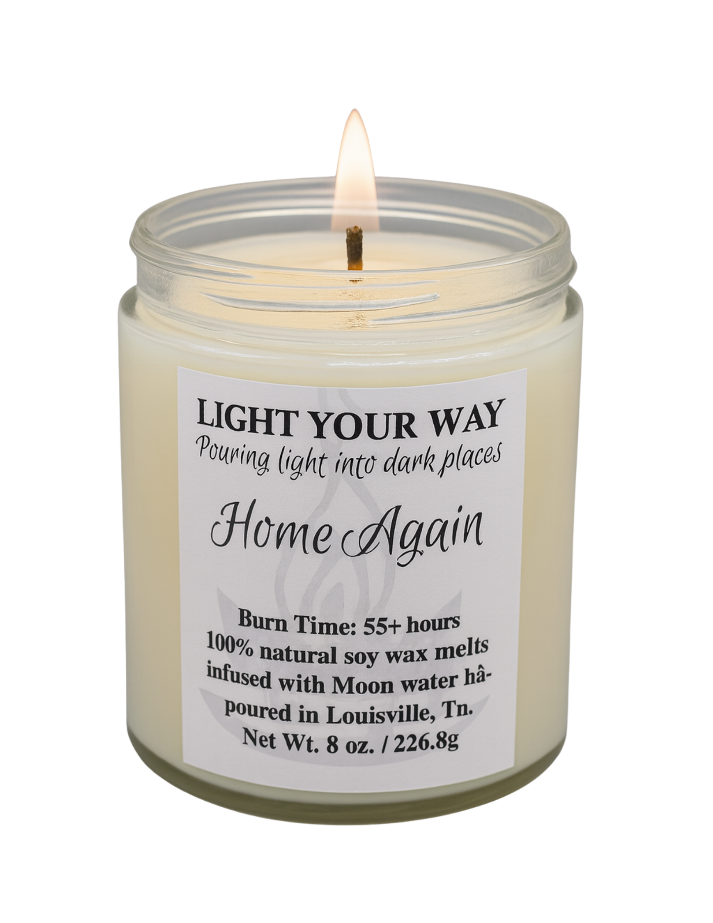 Candle in a glass jar with a home again label on a white background
