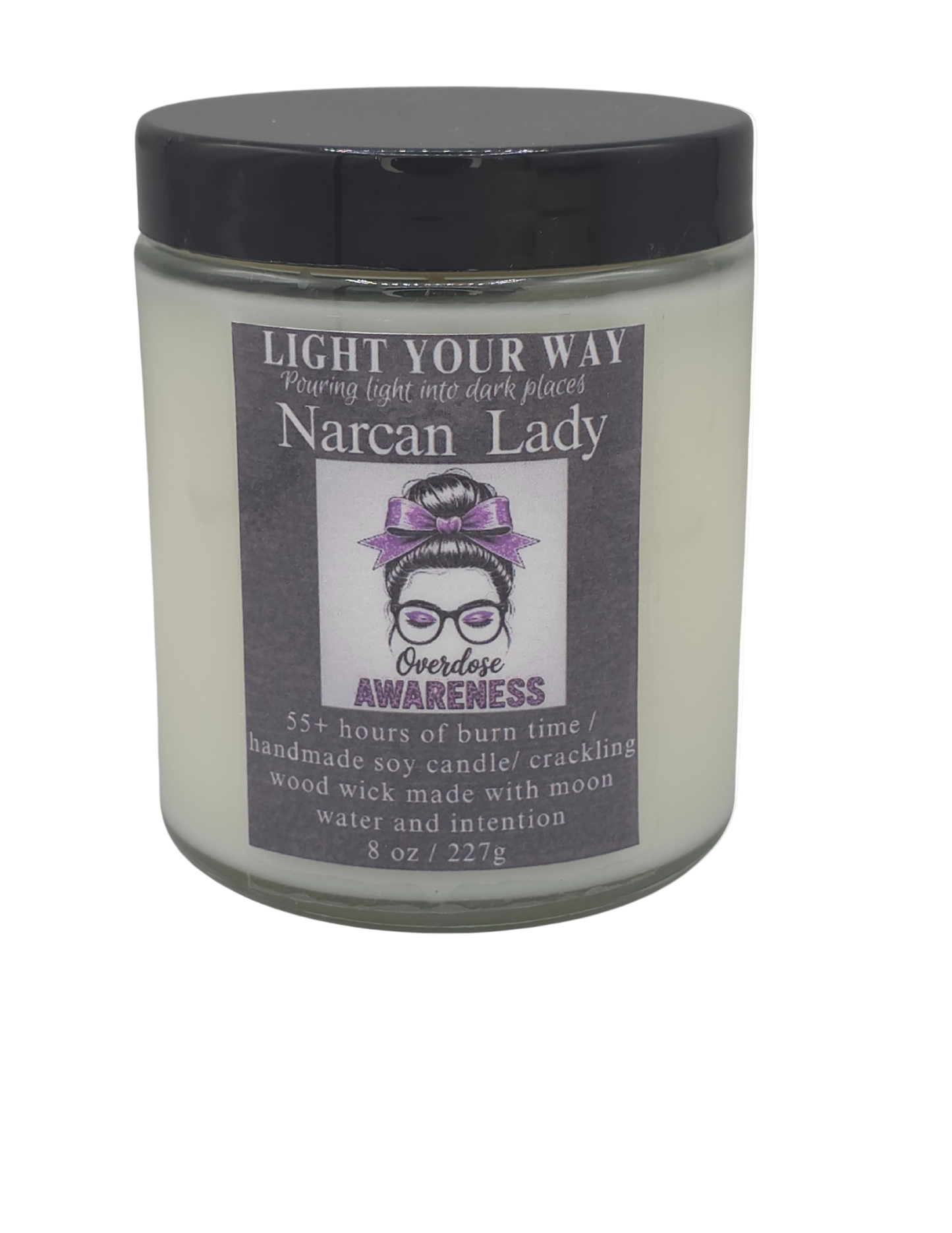 Candle jar with a label with a black lid on it