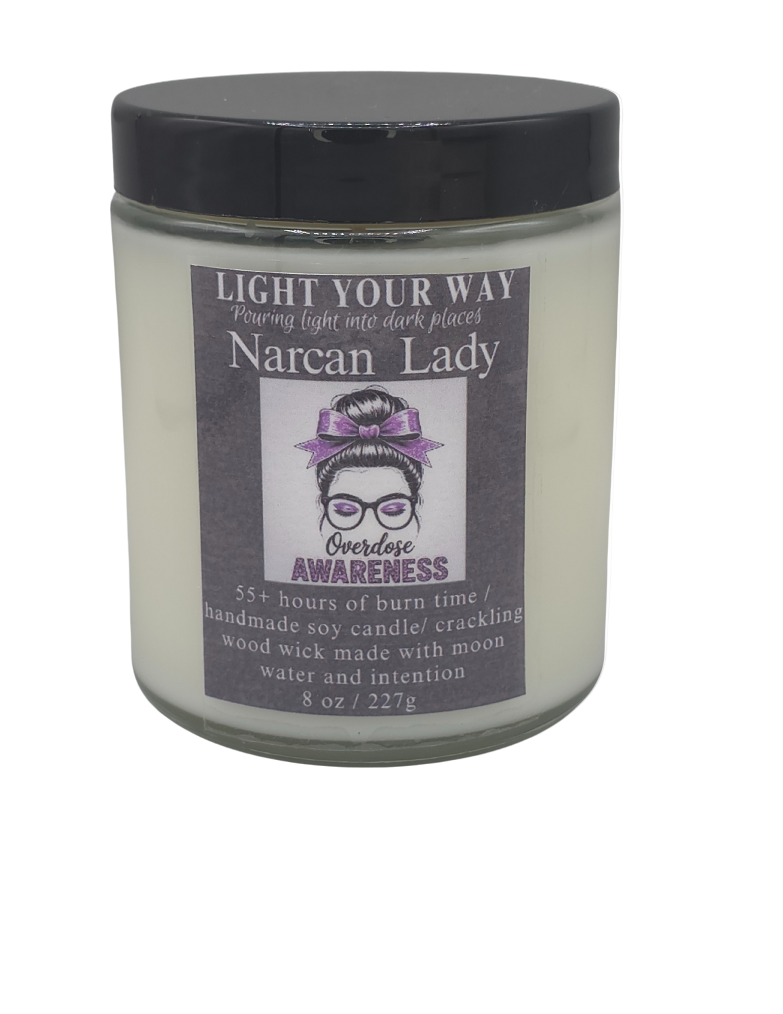 Candle jar with a label with a black lid on it