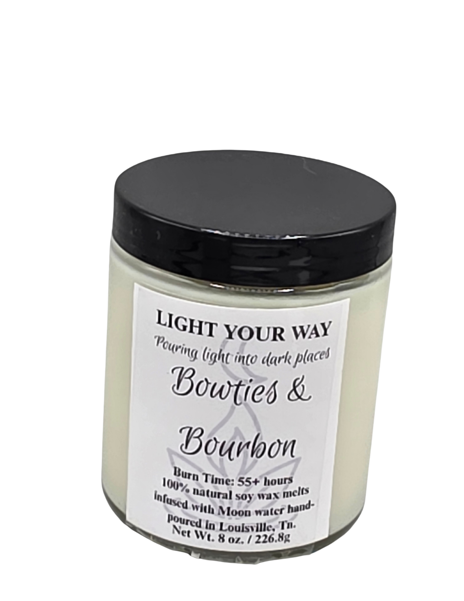 Candle jar with black lid and white label on a white background