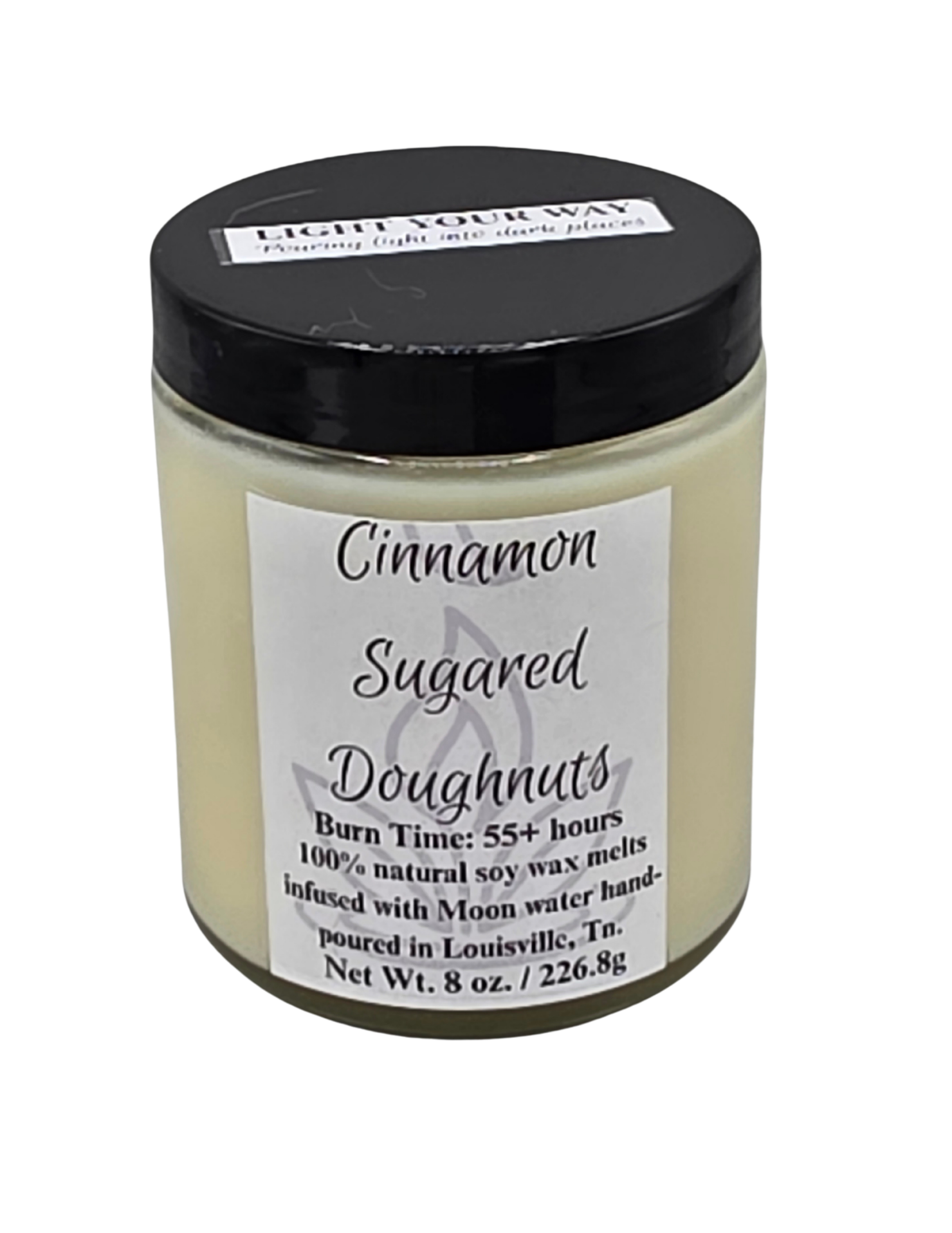 Candle jar labeled 'Cinnamon Sugared Doughnuts' with a black lid 