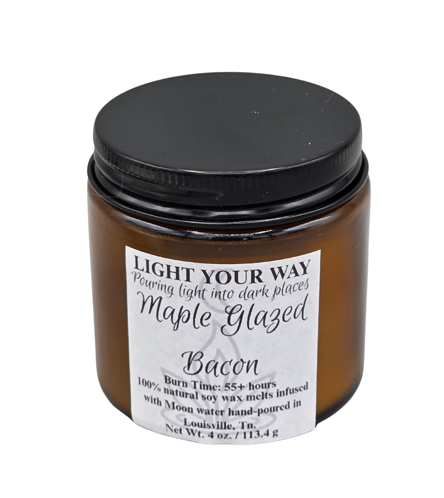 wickless candle in amber jar labeled 'Maple Glazed Bacon' with a black lid on a white background