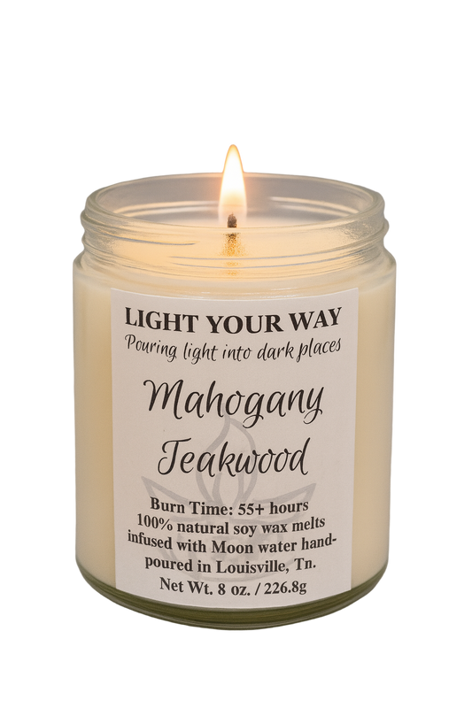Candle in a glass jar with a label titled 'Mahogany Teakwood' 