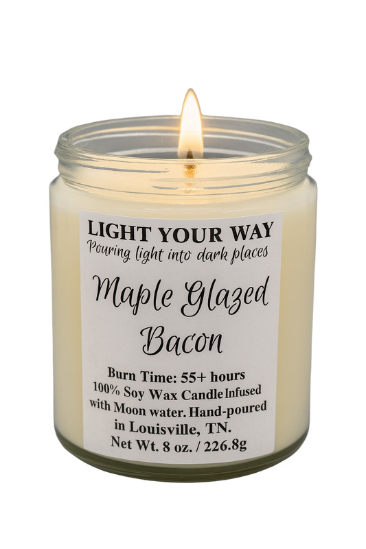 Candle with a label reading 'Maple Glazed Bacon' with a flame